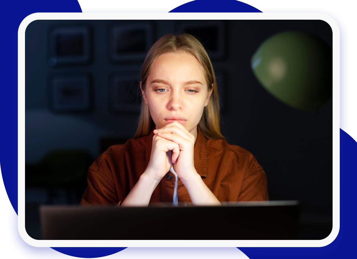 a girl sitting behind a laptop