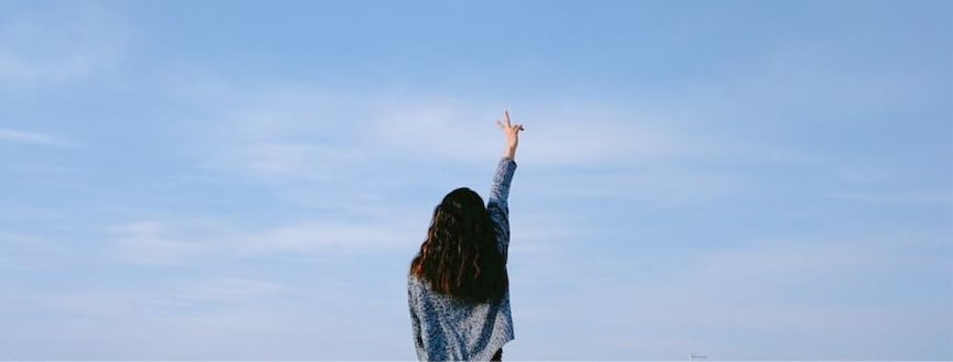 girl stands and shows peace sign as no Instagram DM notification arrives