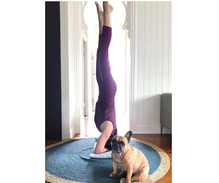 girl doing yoga and a dog